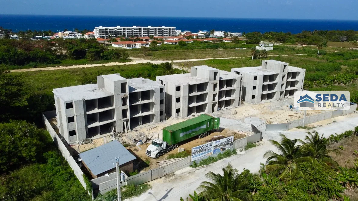 Aerial view of the Brisas Residences structural work and coastal surroundings in Cabrera